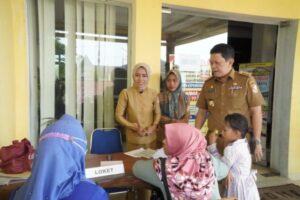 Tinjau Pelayanan Disdukcapil, Bupati Turut Melayani Serahkan KK Kepada Warga